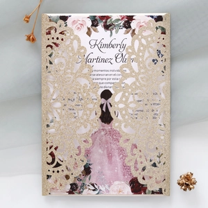 Macro shot of laser-cut glitter wedding invitation with floral girl illustration
