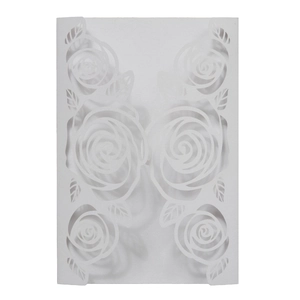 Detail of white pearlescent paper wedding invitation with laser-cut rose floral patterns