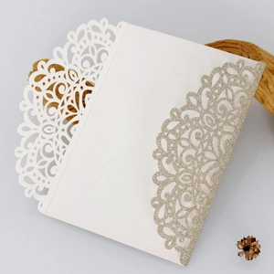 Elegant laser cut wedding invitation with white lace and gold glitter accents
