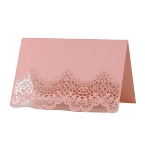 Pink laser-cut lace place cards in pearlescent paper for wedding table seating decor