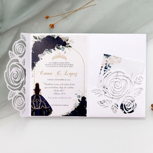 Detail of laser-cut rose invitation with floral inner card and elegant mesh backdrop
