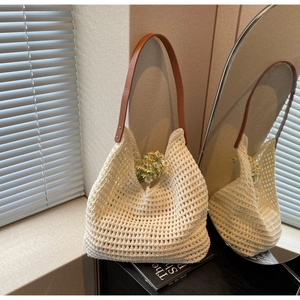 Detail of cream crochet knit tote bag with mesh texture and brown leather strap