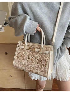 Cream white embroidered handbag with bird patterns and adjustable shoulder strap
