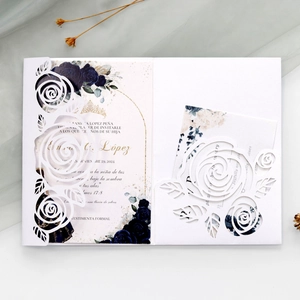 Detail of laser-cut rose wedding invitation with navy blue floral print card