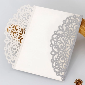 Detail of laser-cut hollow floral pattern invitation with silver glitter finish