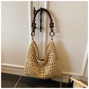 Detailed close-up of handmade woven tote bag with dark brown wooden beaded handle