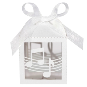Detail of white laser-cut music note gift box with elegant satin ribbon bow