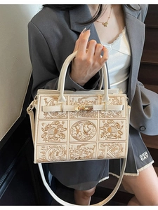 Elegant embroidered cream satchel bag with gold floral patterns and dual handles