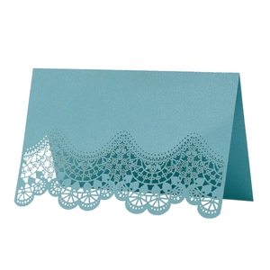 Blue laser-cut lace wedding place card with intricate hollow design and folded stand