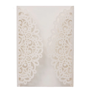 Macro detail of laser-cut glitter wedding invitation with intricate lace patterns