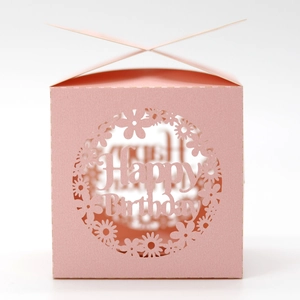 Detail of pink laser-cut birthday favor box with Happy Birthday hollow-out design