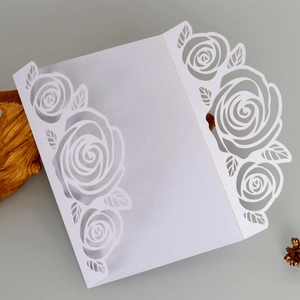 Elegant laser-cut white rose wedding invitation made of premium pearlescent paper