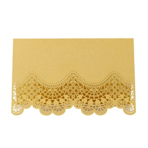 Detail of gold glitter laser-cut lace pattern on elegant wedding place card