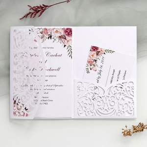 Detail view of laser-cut floral wedding invitation set with watercolor rose insert cards