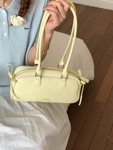 Fashionable cream PU leather baguette bag with bow detail and twin shoulder straps