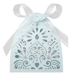 Close-up of light blue laser-cut candy box with elegant floral hollow patterns and white ribbon