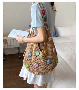 Detail of hand-crocheted shoulder bag with 3D colorful flowers and bohemian woven strap