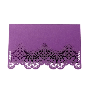 Close-up of dark purple laser cut lace design on a wedding place card for table setting