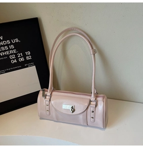 Detail of light pink patent leather bowling bag with heart lock and silver hardware