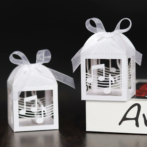 Detailed laser cut musical note patterns on white favor box with elegant silk ribbon