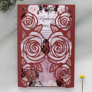 Detail of burgundy laser-cut rose wedding invitation with floral watercolor insert