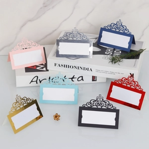 Detail of laser-cut wedding place cards showing hollow cross patterns in 7 vibrant colors