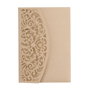 Macro detail of laser-cut floral pattern on champagne pearl paper wedding card cover