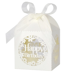 Detail of cream white laser cut gift box with Happy Birthday text and organza ribbon