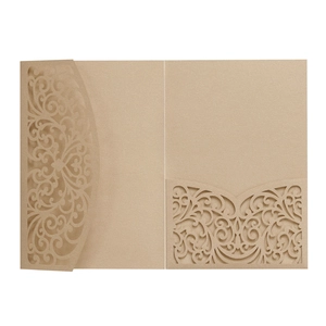Close-up of laser-cut European floral patterns on matte gold wedding invitation card