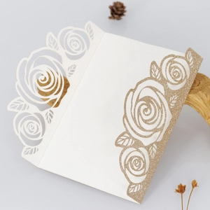 Macro detail of laser cut rose pattern card with shimmering gold glitter finish