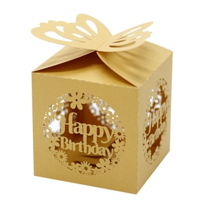 Macro detail of laser-cut gold butterfly gift box with Happy Birthday hollow engraving