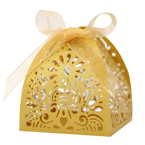 Elegant gold laser-cut favor box with intricate floral patterns and matching ribbon bow
