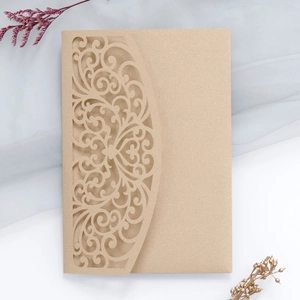Detailed laser-cut hollow pattern on champagne gold wedding invitation card
