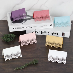 Elegant laser-cut lace name cards in multiple pearlescent colors for wedding tables