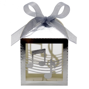 Close-up of silver laser-cut music note gift box with elegant lavender ribbon detail