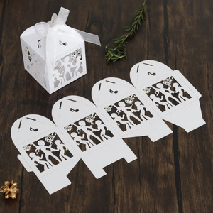Laser cut white paper gift box with dance silhouettes and flat template on wood
