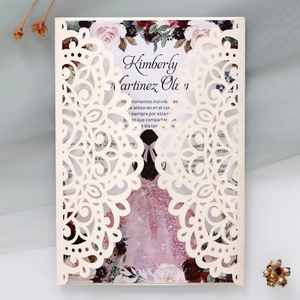 Macro detail of laser-cut glitter silver wedding invitation with floral insert card