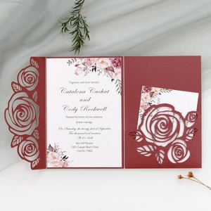 Laser cut burgundy rose wedding invitation with white floral insert on soft tulle