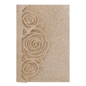 Detailed laser-cut rose patterns on glittery gold paper for wedding invitations