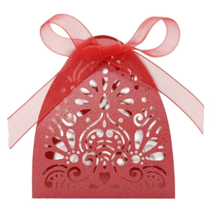 Close-up of laser-cut floral patterns on red wedding candy box with a silk ribbon bow