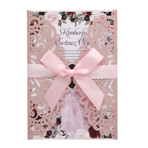 Pink glitter laser-cut floral wedding invitation set with a soft satin ribbon bow