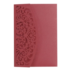 Macro view of burgundy laser-cut hollow floral pattern on pearlescent paper invitation