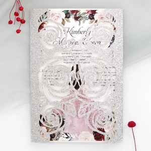 Detail of silver glitter laser-cut rose invitation card with floral interior insert