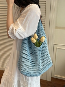 Light blue knit hollow shoulder tote bag with mesh texture and floral beach style