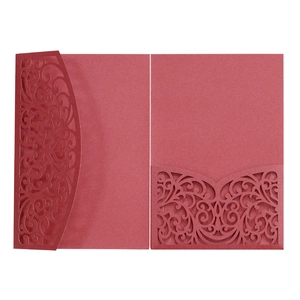 Detail of dark red laser-cut wedding invitation cover with intricate hollow scrollwork