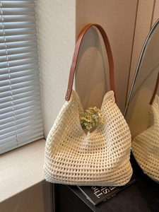 Hollow woven tote bag in cream white with brown leather straps for beach vacation