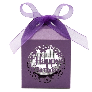 Detail of purple Happy Birthday favor box with laser-cut floral pattern and silk ribbon