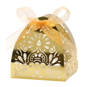 Macro view of gold laser-cut gift box featuring intricate hollow floral patterns