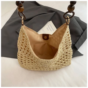 Detail of woven straw tote bag with inner lining, pocket and magnetic closure