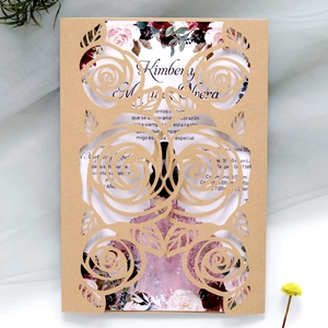 Close-up of laser-cut rose hollow pocket and elegant floral wedding invitation card
